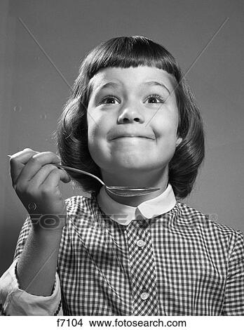 Picture - 1960S Girl With Smiling Yummy Facial Expression Holding Spoon. Fotosearch