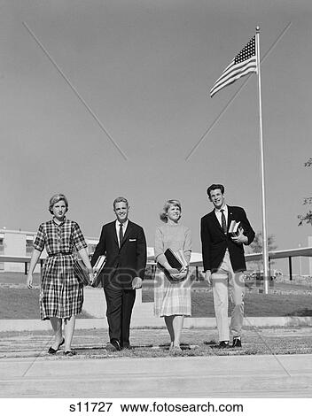 1960S Group 4 High School Students Walking Past American Flag Carrying Textbooks View Large Photo Image Stock Photo - 1960S Group 4 High School Students Walking Past American Flag Carrying Textbooks. Fotosearch