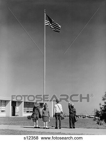 Stock Photo - 1960S Group 4 School Children Looking Up At American Flag. Fotosearch
