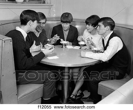 1960S Group Of 5 Teens Sitting At Round Booth Eating Ice Cream Sundaes & Talking View Large Photo Image Stock Photography - 1960S Group Of 5 Teens Sitting At Round Booth Eating Ice Cream Sundaes & Talking. Fotosearch