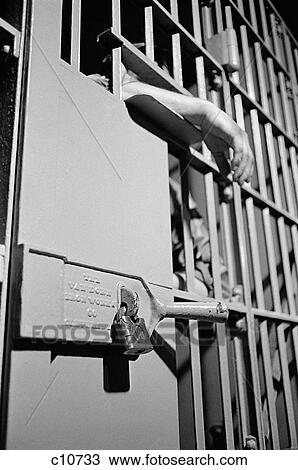 1960S Jail Cell Door With Padlock & Prisoner'S Hand Hanging Out Between Bars View Large Photo Image Stock Image - 1960S Jail Cell Door With Padlock & Prisoner'S Hand Hanging Out Between Bars. Fotosearch