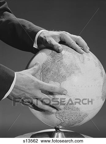 Stock Image - 1960S Male Hands Holding Earth Globe. Fotosearch