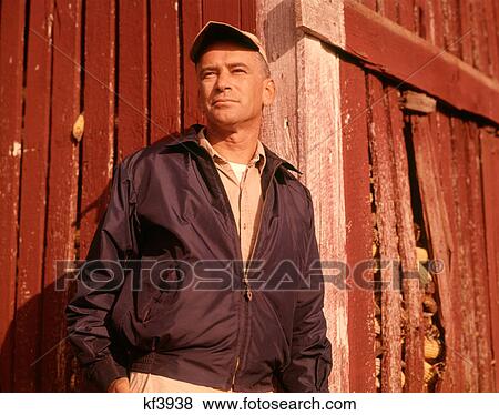1960S Man Farmer Serious Portrait Leaning Against Corn Crib Wearing Cap And Jacket View Large Photo Image Stock Photo - 1960S Man Farmer Serious Portrait Leaning Against Corn Crib Wearing Cap And Jacket. Fotosearch