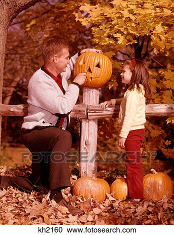 1960S Man Father And Girl Daughter Carving Halloween Jack-O-Lantern Pumpkin View Large Photo Image Stock Image - 1960S Man Father And Girl Daughter Carving Halloween Jack-O-Lantern Pumpkin . Fotosearch
