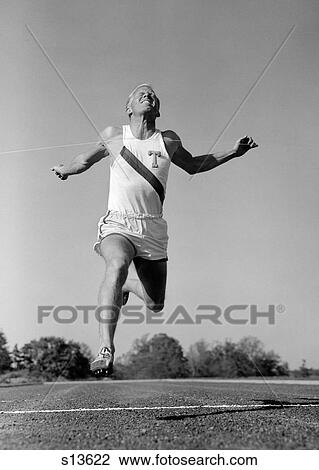1960S Man Running Winning Sprinting Across The Finish Line Outdoor View Large Photo Image Stock Image - 1960S Man Running Winning Sprinting Across The Finish Line Outdoor. Fotosearch