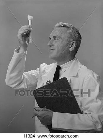 1960S Man Scientist Studying Test Tube View Large Photo Image Picture - 1960S Man Scientist Studying Test Tube. Fotosearch