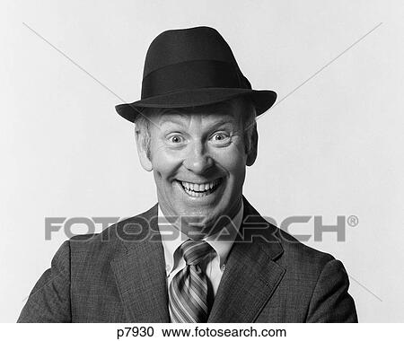 Stock Image - 1960S Man Smiling Wearing Suit And Hat With Silly Eager Facial Expression. Fotosearch