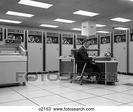 1960S Man Technician Programming Mainframe Computer At Control Room Console Surrounded By Many Tape Drive Data Storage Machines View Large Photo Image Stock Image - 1960S Man Technician Programming Mainframe Computer At Control Room Console Surrounded By Many Tape Drive Data Storage Machines. Fotosearch