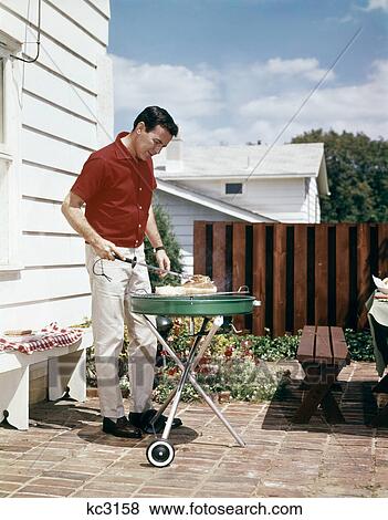 1960S Man Wearing Red Shirt Grilling Steak On Backyard Brick Patio View Large Photo Image Stock Photo - 1960S Man Wearing Red Shirt Grilling Steak On Backyard Brick Patio. Fotosearch
