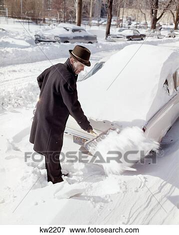 Stock Photo - 1960S Man With Snow Shovel Digging Out Car Covered By Blizzard . Fotosearch
