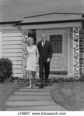 1960S Mature Couple Walking On Sidewalk Front Of House View Large Photo Image Stock Photo - 1960S Mature Couple Walking On Sidewalk Front Of House. Fotosearch