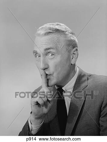 Picture - 1960S Middle Aged Man Finger To Lips Making Quiet Shush Sign Looking At Camera. Fotosearch