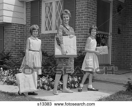 1960S Mother And Two Daughters Carrying Shopping Bags Packages Into House Looking At Camera View Large Photo Image Stock Image - 1960S Mother And Two Daughters Carrying Shopping Bags Packages Into House Looking At Camera. Fotosearch