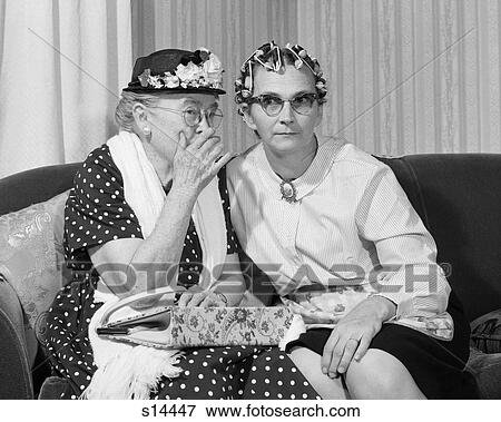 1960S Older Women On Couch Sharing Secret One In Flowered Hat One In Hair Curlers View Large Photo Image Stock Photo - 1960S Older Women On Couch Sharing Secret One In Flowered Hat One In Hair Curlers. Fotosearch