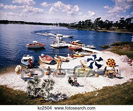 1960S People On Small Sandy Beach Umbrellas Boats Summer Fun Vacation Florida Cypress Gardens View Large Photo Image Picture - 1960S People On Small Sandy Beach Umbrellas Boats Summer Fun Vacation Florida Cypress Gardens. Fotosearch