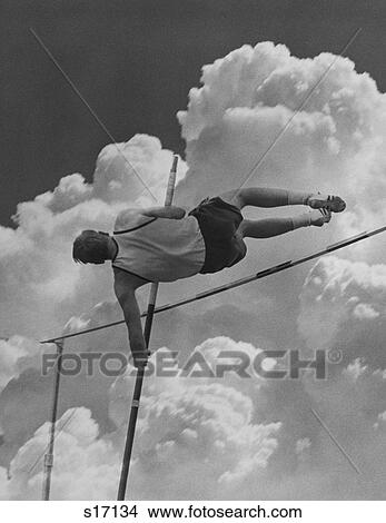 Picture - 1960S Pole Vaulter Man Against Sky And Clouds. Fotosearch