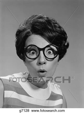 Stock Photo - 1960S Portrait Brunette Wearing Dark Thick Round Eyeglasses With Eyes Wide Open. Fotosearch