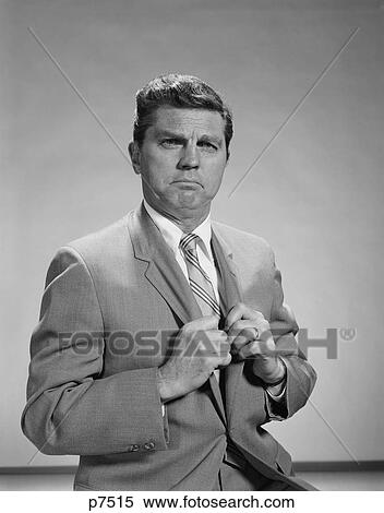 1960S Portrait Middle Aged Man Stern Serious Expression Hands Gripping His Lapels Looking At Camera View Large Photo Image Stock Photography - 1960S Portrait Middle Aged Man Stern Serious Expression Hands Gripping His Lapels Looking At Camera. Fotosearch