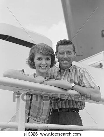 1960S Portrait Smiling Couple Standing By Shipboard Rail Looking At Camera View Large Photo Image Stock Photograph - 1960S Portrait Smiling Couple Standing By Shipboard Rail Looking At Camera. Fotosearch