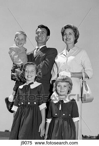 1960S Portrait Smiling Family Father Mother Two Daughters Son Standing Together Outdoors View Large Photo Image Stock Photography - 1960S Portrait Smiling Family Father Mother Two Daughters Son Standing Together Outdoors. Fotosearch
