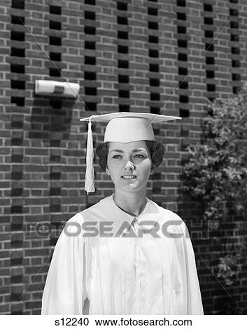 Stock Image - 1960S Portrait Teen Girl White Cap And Gown Graduation Robe. Fotosearch