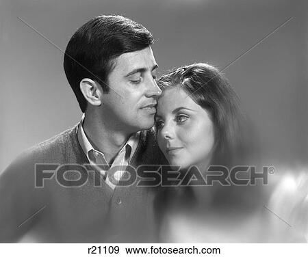 1960S Romantic Portrait Man Touching His Lips To Woman'S Forehead View Large Photo Image Stock Photo - 1960S Romantic Portrait Man Touching His Lips To Woman'S Forehead. Fotosearch