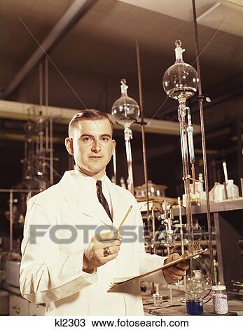 Stock Image - 1960S Scientist Conducting A Titration Experiment. Fotosearch