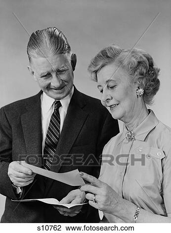 1960S Senior Couple Man Woman Reading Holding Check View Large Photo Image Stock Image - 1960S Senior Couple Man Woman Reading Holding Check. Fotosearch