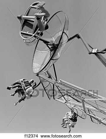 1960S Shot Of Couples Seated On Moving Amusement Park Ride View Large Photo Image Picture - 1960S Shot Of Couples Seated On Moving Amusement Park Ride. Fotosearch