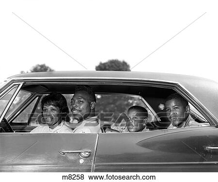 1960S Side View Outdoor Smiling African-American Family Father Mother Two Sons Sitting In Four Door Sedan Automobile View Large Photo Image Stock Photo - 1960S Side View Outdoor Smiling African-American Family Father Mother Two Sons Sitting In Four Door Sedan Automobile. Fotosearch