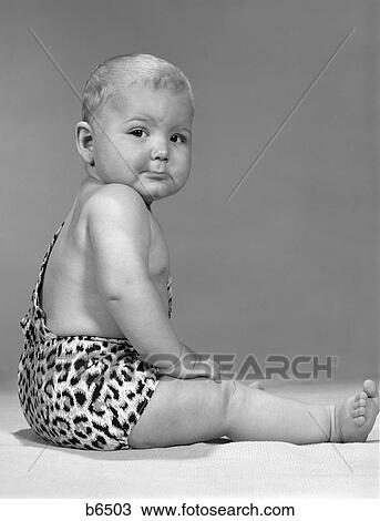 1960S Side View Portrait Grumpy Expression Baby In Leopard-Spotted Tarzan Strongman Caveman Costume View Large Photo Image Stock Image - 1960S Side View Portrait Grumpy Expression Baby In Leopard-Spotted Tarzan Strongman Caveman Costume. Fotosearch