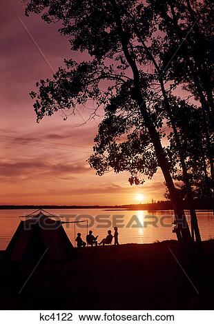1960S Silhouette Of Family Camping By Lake At Sunset View Large Photo Image Stock Image - 1960S Silhouette Of Family Camping By Lake At Sunset. Fotosearch