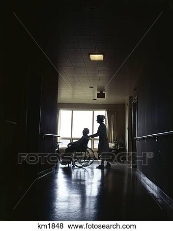 1960S Silhouetted Nurse Pushing Patient In Wheelchair Hospital View Large Photo Image Stock Photo - 1960S Silhouetted Nurse Pushing Patient In Wheelchair Hospital. Fotosearch