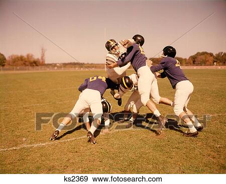 1960S Six Football Players Running Blocking Tackling On Scrimmage Field View Large Photo Image Stock Photo - 1960S Six Football Players Running Blocking Tackling On Scrimmage Field. Fotosearch