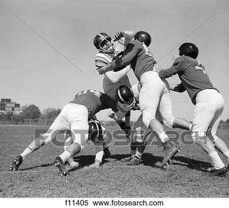 Stock Photography - 1960S Six Men Playing Football Group Tackle. Fotosearch