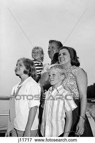 1960S Smiling Family Portrait Father Mother Two Daughters Son Standing Together Outdoors View Large Photo Image Stock Photo - 1960S Smiling Family Portrait Father Mother Two Daughters Son Standing Together Outdoors. Fotosearch