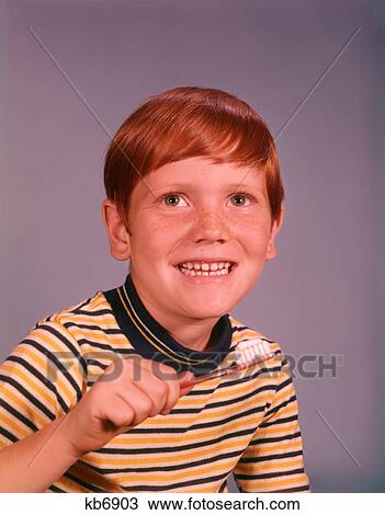 1960S Smiling Happy Boy Red Hair Striped Tee Shirt Holding Toothbrush Brushing Teeth View Large Photo Image Stock Image - 1960S Smiling Happy Boy Red Hair Striped Tee Shirt Holding Toothbrush Brushing Teeth . Fotosearch