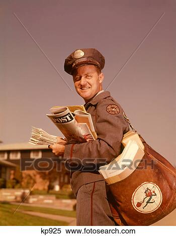 Stock Photography - 1960S Smiling Mailman Holding Mail Mailbag Letters Leather Mailbag In Suburban Neighborhood. Fotosearch