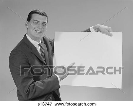1960S Smiling Man Pointing To Blank Poster Looking At Camera View Large Photo Image Stock Photo - 1960S Smiling Man Pointing To Blank Poster Looking At Camera. Fotosearch