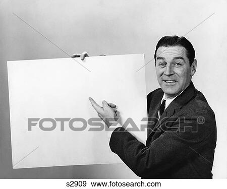 1960S Smiling Man Pointing To Blank Poster Sign View Large Photo Image Stock Photo - 1960S Smiling Man Pointing To Blank Poster Sign. Fotosearch