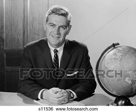 1960S Smiling Man Sitting At Desk With Earth Globe Looking At Camera View Large Photo Image Stock Photograph - 1960S Smiling Man Sitting At Desk With Earth Globe Looking At Camera. Fotosearch