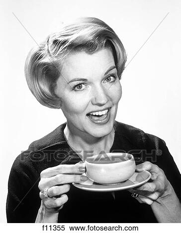 Stock Photography - 1960S Smiling Woman Drinking Coffee Holding Cup And Saucer. Fotosearch