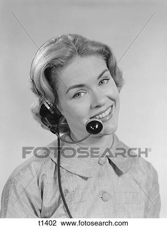 Stock Image - 1960S Smiling Woman Telephone Operator Wearing Headset. Fotosearch