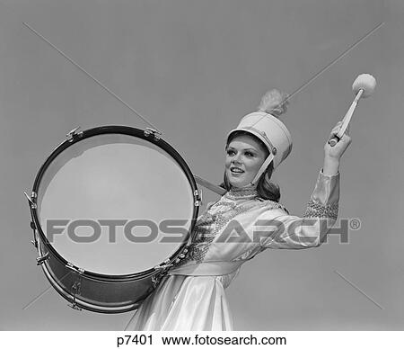 Stock Image - 1960S Smiling Young Woman Band Uniform Carrying Playing Big Drum. Fotosearch