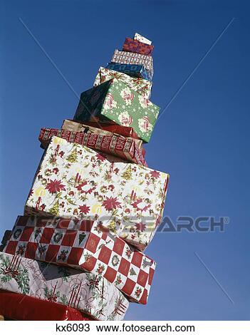 Stock Image - 1960S Tall Pile Christmas Presents Gift Wrapped. Fotosearch