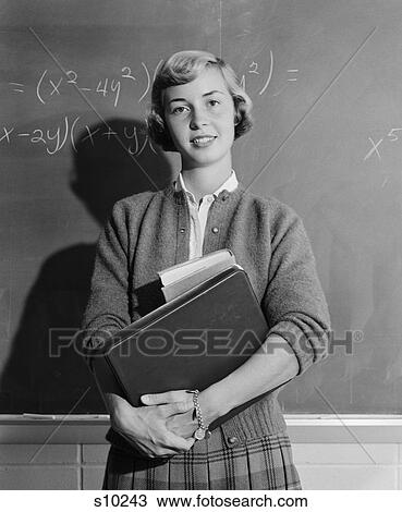 1960S Teenage Girl Holding School Books Standing In Front Of Blackboard Looking At Camera View Large Photo Image Stock Image - 1960S Teenage Girl Holding School Books Standing In Front Of Blackboard Looking At Camera. Fotosearch