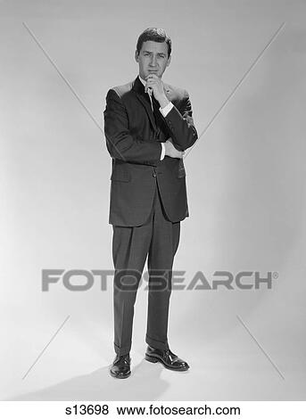 1960S Thoughtful Businessman Standing Holding Hand To Chin View Large Photo Image Stock Photo - 1960S Thoughtful Businessman Standing Holding Hand To Chin. Fotosearch