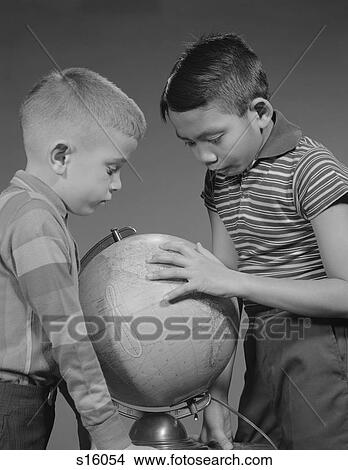 Picture - 1960S Two Boys Studying Earth Globe . Fotosearch