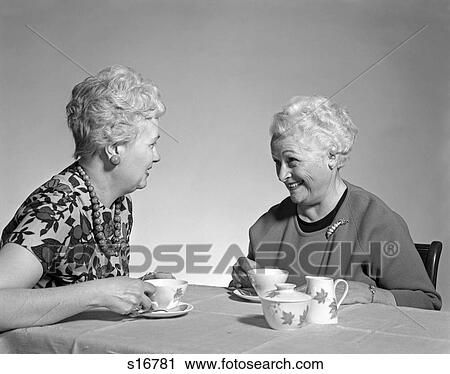 1960S Two Mature Senior Women Drinking Tea Coffee At Table And Talking Chatting Gossiping View Large Photo Image Stock Image - 1960S Two Mature Senior Women Drinking Tea Coffee At Table And Talking Chatting Gossiping. Fotosearch