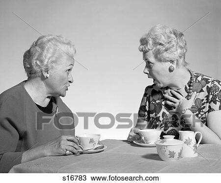 1960S Two Mature Senior Women Drinking Tea Coffee At Table And Talking Chatting Gossiping View Large Photo Image Stock Image - 1960S Two Mature Senior Women Drinking Tea Coffee At Table And Talking Chatting Gossiping. Fotosearch